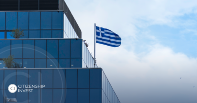 Modern building with Greek flag, symbolizing the revival of real estate investment opportunities in Greece.