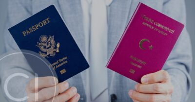 Person holding two passports from different countries representing dual citizenship